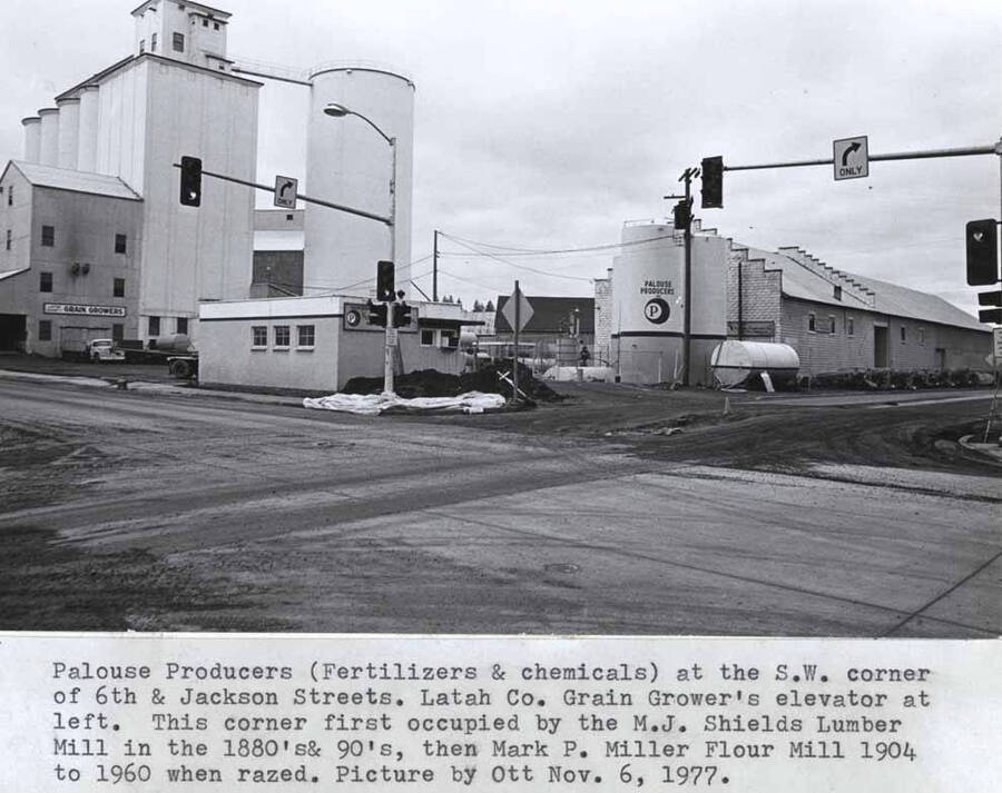 Fertilizers and chemicals at the southwest corner of Sixth and Jackson streets. Latah County Grain Growers  elevator at left. This corner first occupied by the Michael J. Shields lumber mill in the 1880s and 1890s. Then Mark P. Miller flour mill, 1904 to 1960 when razed. Picture by Clifford M. Ott November 6, 1977.