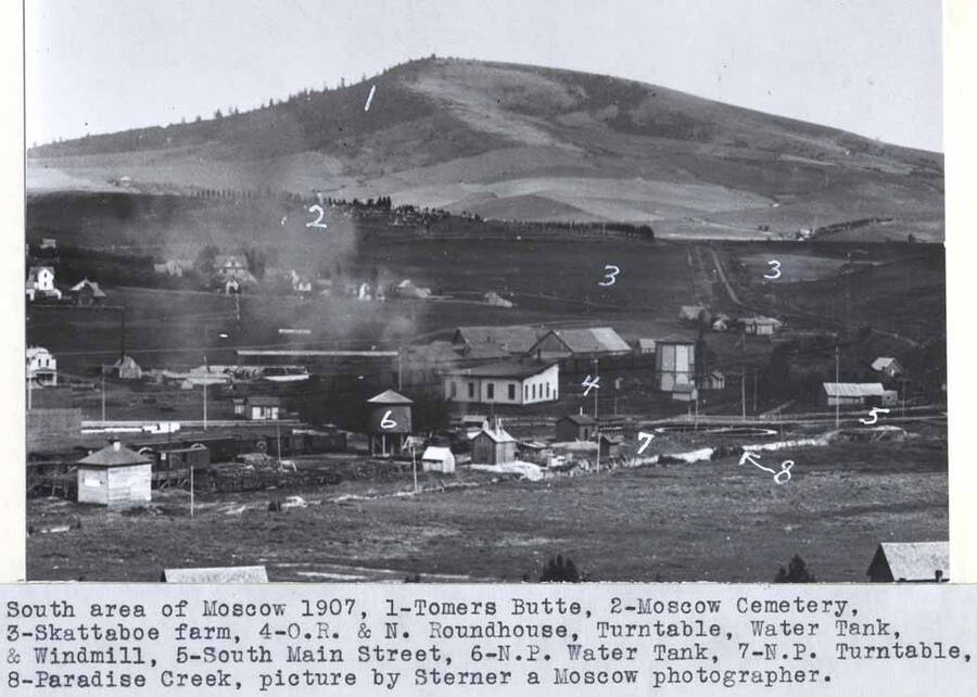 1- Tomers Butte, 2- Moscow Cemetery, 3- Skattaboe farm, 4- O.R. & N.  [Oregon Railroad and Navigation] roundhouse, turn table, water tank, and windmill, 5- South Main Street, 6- N.P. [Northern Pacific Railroad] water tank, 7- N.P. [Northern Pacific Railroad] turn table, 8- Paradise Creek, picture by Sterner, a Moscow photographer.