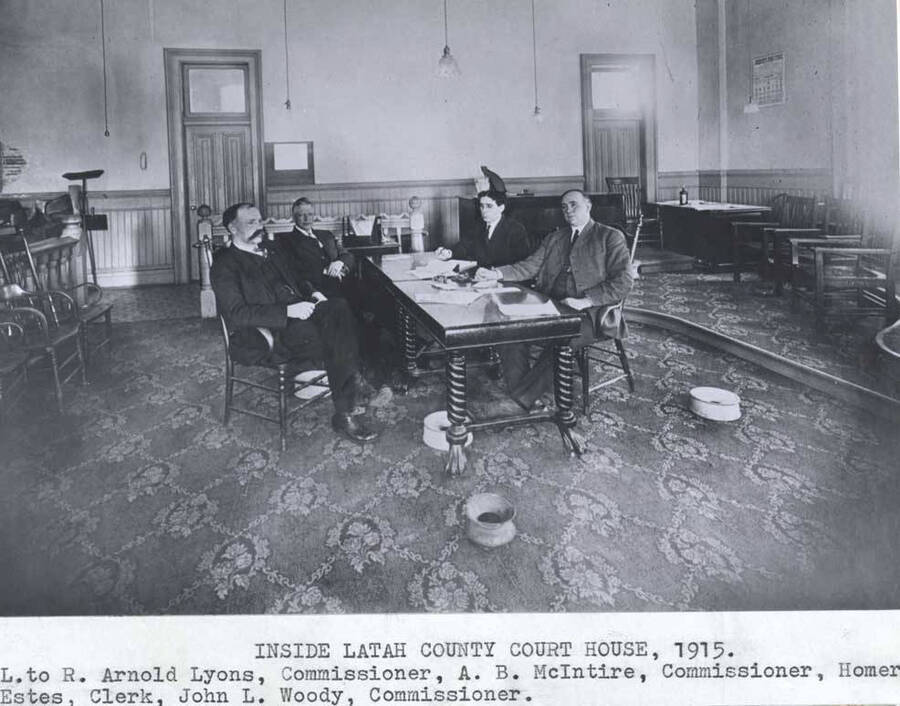 Left to right: Arnold Lyons, Commissioner. A.B. McIntire, Commissioner. Homer Estes, Clerk. John L. Woody, Commissioner.