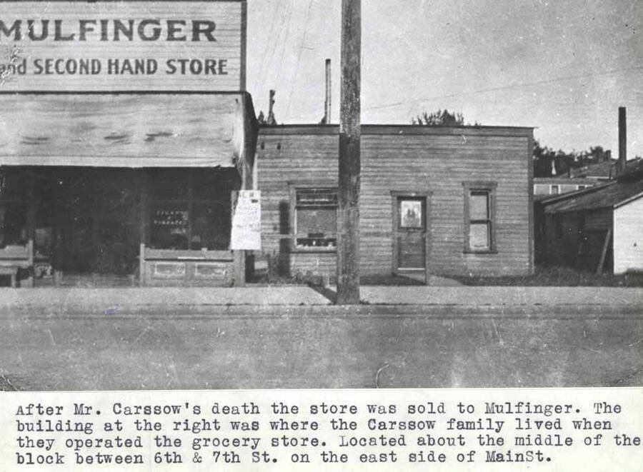 After Mr. Carssow's death the store was sold to Mulfinger. The building at the right was where the Carssow family lived when they operated the grocery store. Located about the middle of the block between Sixth and Seventh streets on the east side of Main Street.
