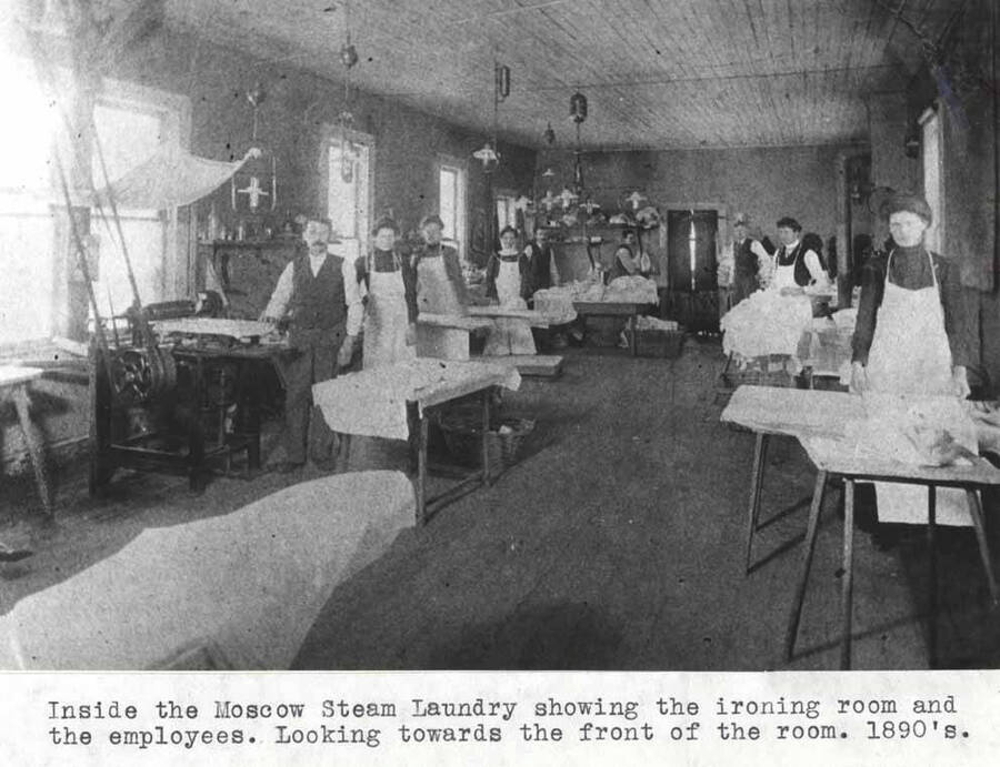 Showing the ironing room and the employees. Looking towards the front of the room. 1890s.