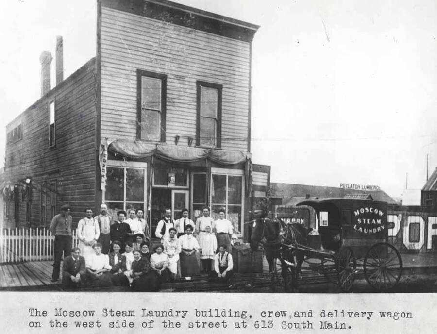 Crew and delivery wagon on the west side of the street at 613 South Main Street.