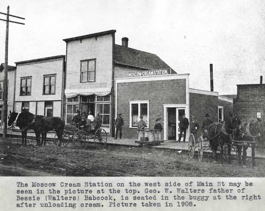 On the west side of Main Street. George W. Walters, father of Bessie (Walters) Babcock, is seated in the buggy at the right after unloading cream. Picture taken in 1908.