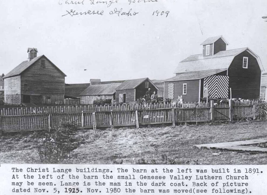 The barn at the left was built in 1891. At the left of the barn the small Genesee Valley Lutheran Church may be seen. Lange is the man in the dark coat. Back of picture dated November 5, 1915. Nov. 1890 the barn was moved (see following) [90-4-028].
