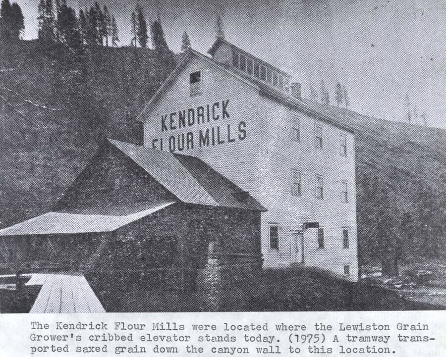 The Kendrick flour mills were located where the Lewiston Grain Growers cribbed elevator stands today. (1975). A tramway transported sacked grain down the canyon wall to this location.