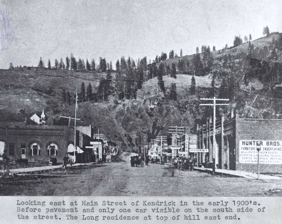 In the early 1900s. Before pavement and only one car visible on the south side of the street. The Long residence at top of hill east end.
