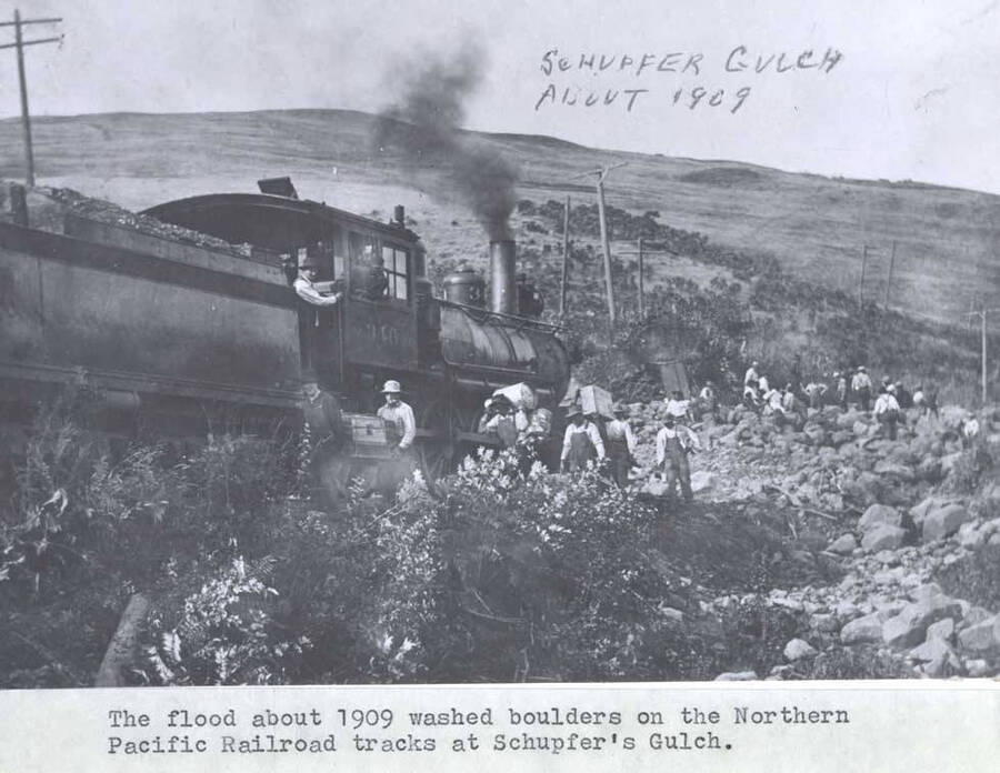 The flood about 1909 washed boulders on the Northern Pacific Railroad tracks at Schupfer's Gulch.