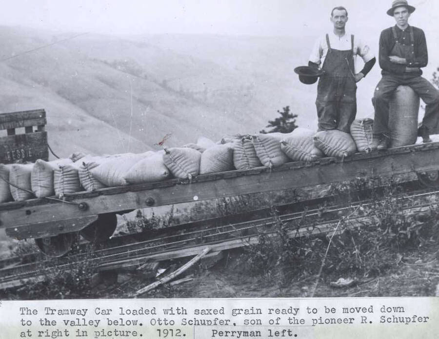 Loaded with sacked grain ready to be moved down to the valley below. Otto Schupfer, son of the pioneer R. Schupfer at right in picture. 1912. [Arthur] Perryman left.