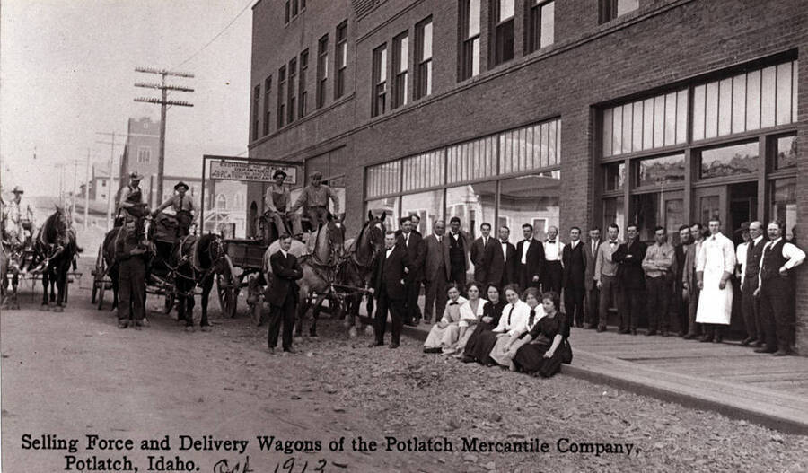 Seventh annual sale October 10, 11, 1913. Wording on photo: "Selling force and delivery wagons of the Potlatch Mercantile Company, Potlatch, Idaho. Oct. 1912."