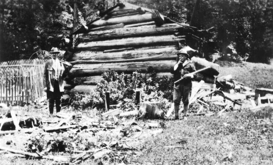 Built in the late 1860s located about one-and-one-half miles north of Gold Hill in Township 42 N. Range 4 West, Section 11 near the Carrico Gold Mine. Left to right: Paul Bockmier and Mr. Brown with gun. Picture taken in 1924.