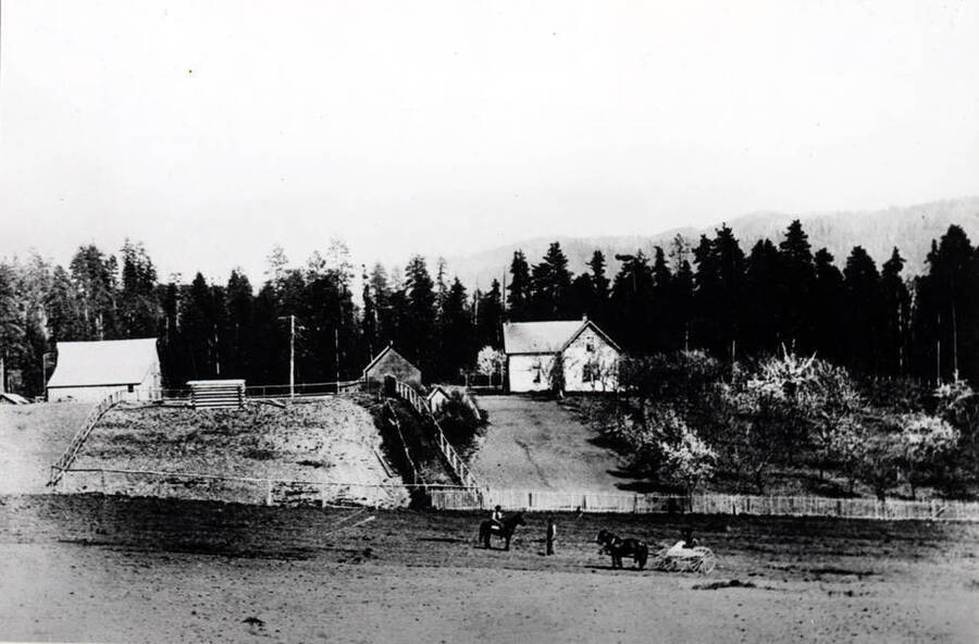 Formerly the Ed Swenson [homestead] of 80 acres located north of the S.W. [section?] of Township 39N. Range 1 west. Swenson family in foreground. Early 1900s.
