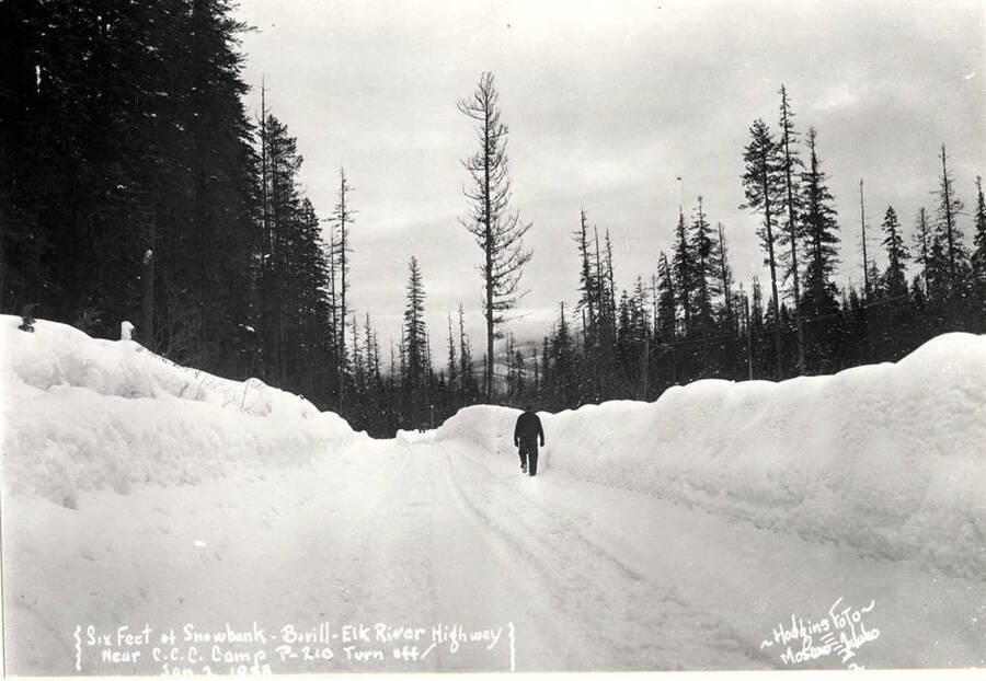 Wording on photo: Six feet of snowbank - Bovill - Elk River Highway near C.C.C. camp P-210 turn off, January 2, 1933. Hodgins Foto Moscow, Idaho.