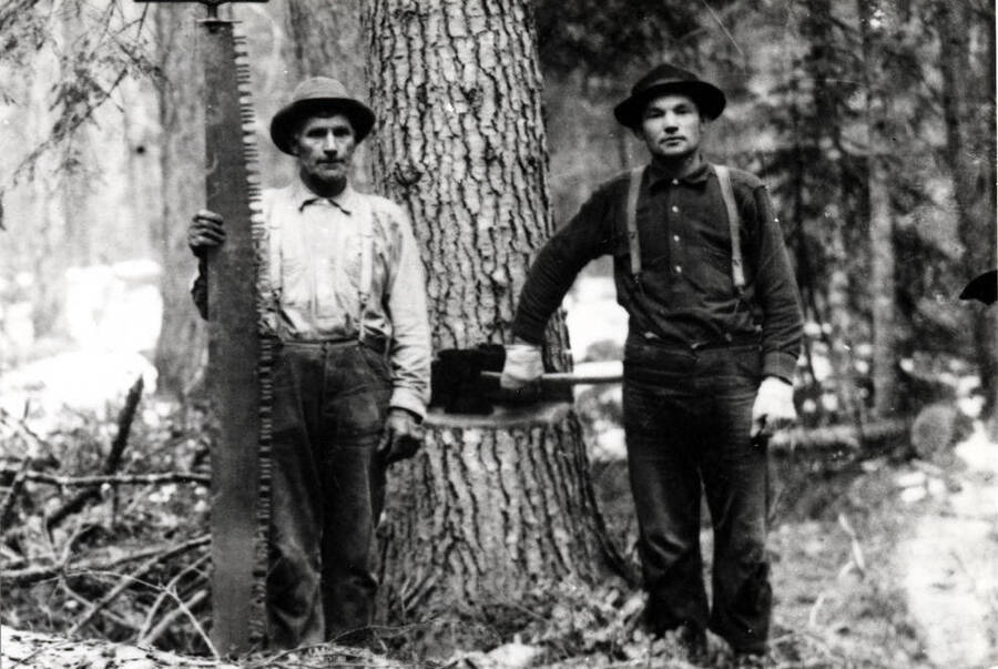 With the tools of their trade. Crosscut saw and double bit axe. Picture by M.L. Romig of Moscow about 1910.