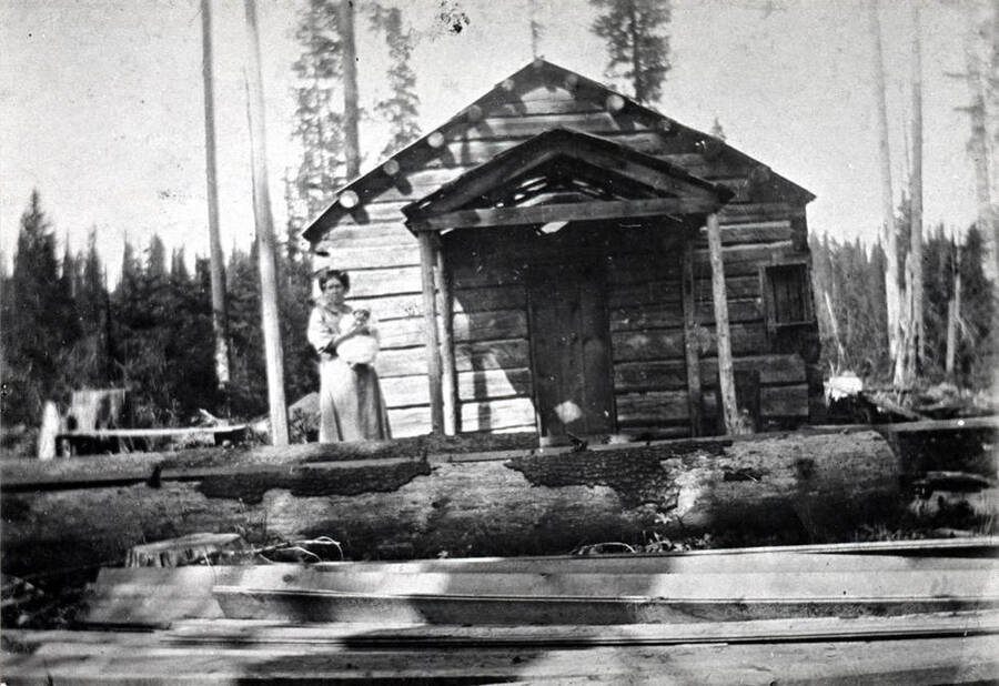 Log cabin schoolhouse at Collins in 1908, located four miles north of Bovill. One of the first teachers was Myrtle Gehrett, who later became Mrs. Sam Frei.