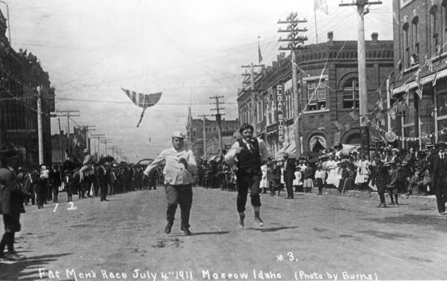 July 4, 1911. (Photo by Burns) Several fat men and Casper Tylden in the dark vest and pants entered the race. Someone said put a rider on the big Swede he is not a fat man, however he weighed the minimum. The other fat men who started the race had dropped out when the picture was taken. Tylden was just gaining his speed at this point and won the race by quite a margin. His comment after the race was, 'If we had to have gone further I would have beat him badly.' No. 1 in picture is John Ott and no. 2 Clifford M. Ott, 14-years-old. Tylden was our neighbor.