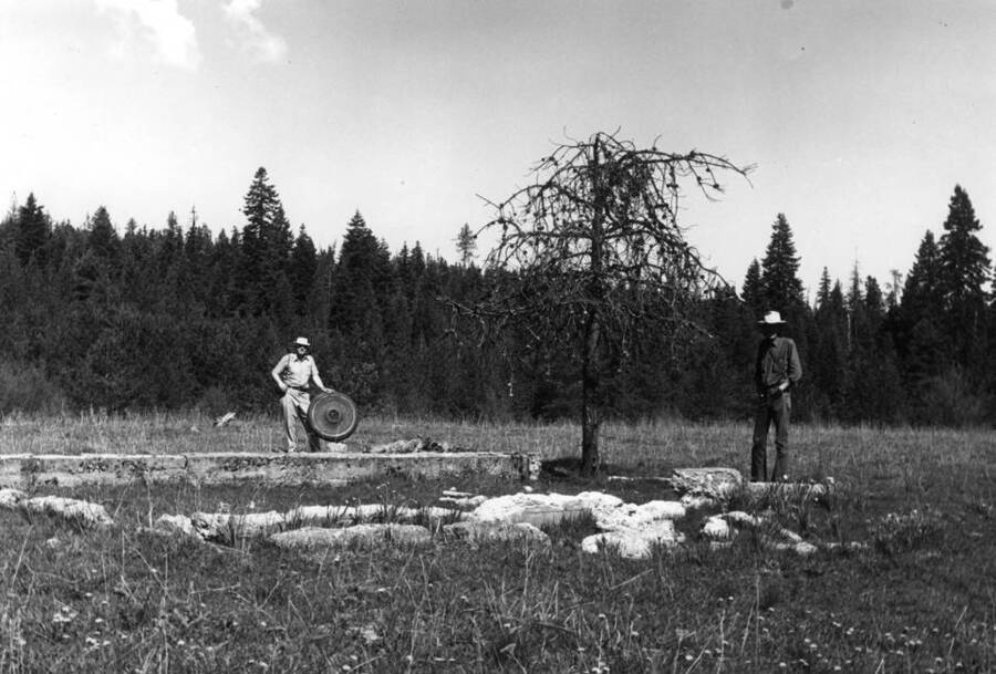 Looking northwest at the foundation of the first J.J. Johnson home about one-quarter mile south of the cemetery. See map on preceding page [90-5-080]. Albert Clausen at left, Max Halstrom, anthropologist at right. This home was later moved to a new location west of the present home, and now is incorporated in the present home. Note flowers in bloom top picture [90-5-081]. Clausen at well location. Pictures May 9, 1976.
