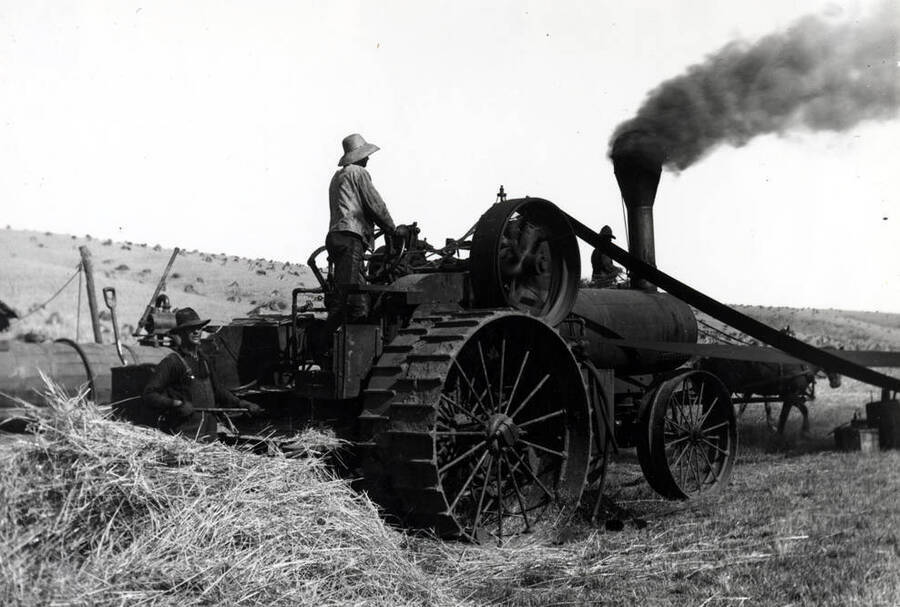 Threshing scene on the Lewis C. Love farm southeast of Garfield showing the steam engine fired with straw. Picture taken by Cecil Love about 1913. Picture made from a 4 x 5' glass negative.