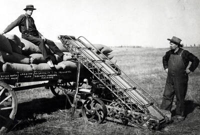 Brown's loading machine, loaded 40 sacks in three-and-one-half minutes. Man on load of grain [is] Mr. Sturdevent, father of C.E. Sturdevent, 422 North Hayes Street, Moscow. Picture taken in the Colfax area by Wicker.