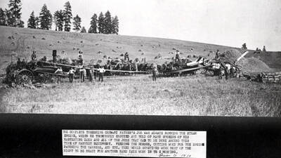 Threshing outfit in the Troy area harvesting bundled grain. Thresher powered by a wood-burning steam engine about 1910. Caption on photo: The complete threshing crew--my father's job was always running the steam engine, which he thoroughly enjoyed and told of many stories of his harvesting days and all of the jobs that had to be done around this type of harvest equipment. Feeding the horses, cutting wood from the engine, patching the harness, and etc. They would sometimes work most of the night to be ready for another hard days work in the morning. Dorothy ?Horn/Moon? Prior to 1910.