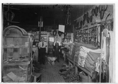 Inside the George Weber Harness Shop at the northeast corner of Third and Main streets. George Weber at left in picture.