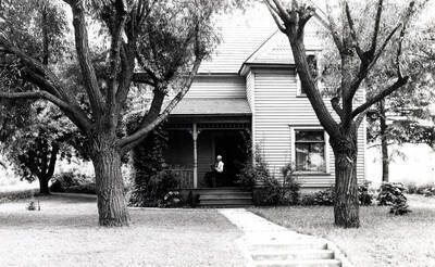 Cornelson residence south side of Sixth Street between Pine and Line streets due north of Morrill Hall. Cornelson on porch.