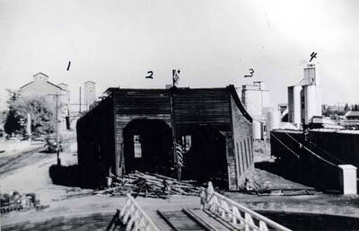 1- Moscow Idaho Seed Company, 2 -Oregon Railroad & Navigation Company roundhouse (U.P. [Union Pacific]) being razed, 3- Latah County Grain Growers concrete elevator Sixth and Jackson streets, 4- Latah County Grain Growers concrete elevator Eighth and Main streets.