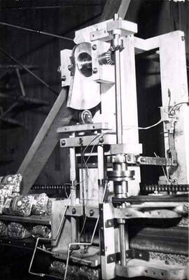 Machine was built by Clifford M. Ott in his basement workshop at 836 Orchard Avenue, [Moscow, Idaho]. It was a semi-automatic machine to pack 24 one-pound cellophane bags into the case. Production of the new automatic cellophane bag machine was faster than a girl could pack them in the case. With this machine, the faster production could be handled easily. Sawyer of Los Angeles, who built the cellophane bag machine copied, with improvements, this machine and built five to operate with the cellophane bag machines at Ralston, Nebraska.
