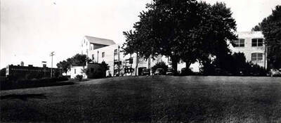 Looking southwest at the east end of the two Washburn-Wilson Seed Company plants no. 1 and 2. In 1945 a one-story flathouse was built connecting the two plants, giving Washburn-Wilson 712 feet front on the [Northern] Burlington [Railroad] siding. Small brick building was the apartment where Clifford M. Ott stayed while at Ralston from October 1942 to January 1945.