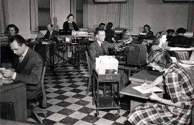 Back office at peak of Washburn-Wilson Seed Company packaging business about 1950. Rollin (Roland) Hill at left. Hodgins Drug Store, Charles Dimond, photographer.