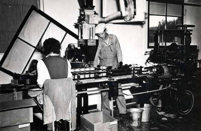 One-pound carton machine packaging whole peas for the grocery trade. Jim Hall was the operator for the three packaging machines in the room.