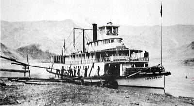 Lewiston running the daily routine of a Pacific Northwest utility boat: nose to the bank long enough to muscle the freight aboard and throw off the mail, possibly pick up a couple of paying passengers, then on to the next mud landing.