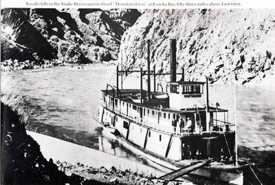 Basalt cliffs in the Snake River canyon dwarf "Mountain Gem" at Eureka Bar, fifty-three miles above Lewiston.