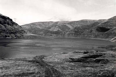 Same area as 90-10-059 showing the water starting to rise from the gates being closed on the Lower Granite Dam. February 15, 1975.