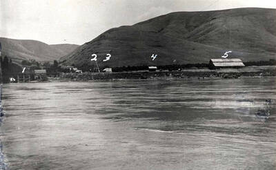 Looking east across Snake River at Wawawai, Washington early 1900s. 1- Oregon Railroad & Navigation Company bridge across creek. See road at right under bridge going to ferry. 2- Tower supporting ferry cable. 3- Wawawai store and post office. 4- Oregon Railroad and Navigation Company depot. 5- Fruit packing building. Picture furnished by Ester Smith, Pullman, Washington.