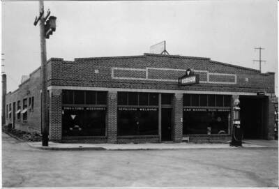 Neely and Sons Garage to be razed for city parking lot. Located on the south side of Fourth Street between the alley and Jackson Street.