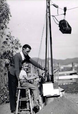 At the controls of Reyborn's drag shovel for removing sand from the South Palouse [River] to dump into wagons.