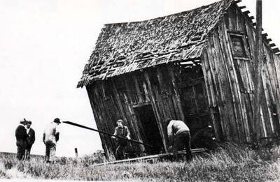 [Photo of newspaper photo and caption]. Located two miles west of the Clinton cemetery and 0.3 miles south of the South Palouse River Road.