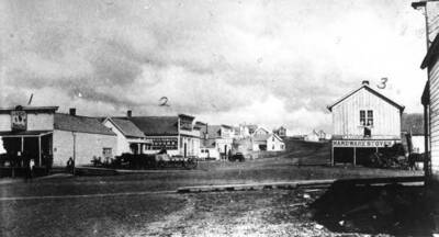No. 1- George Weber harness shop, 2- Saloon, one of several, 3- Langdon Hardware & Stage office. Picture 1885.