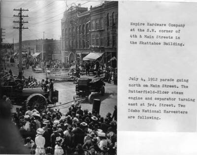 Butterfield-Elder steam engine and separator turning east at Third Street. Two Idaho National Harvesters are following.