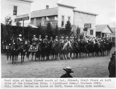 Fruit store at left site of the Lieuallen Building. (Bjorklund Hardware) Picture 1885. Colonel Robert Barton on horse at left. Women riding side saddle.