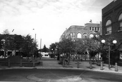 Looking west from Fourth Street across Main Street showing telephone building (#1) and Hotel Moscow (#2). By Clifford M. Ott September 30, 1983.