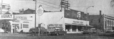 Make Way for Bank Change -- The north side of the 100 block on West Third street, shown in the photo above, will undergo a face lifting in the next six months to provide modern facilities for First Security Bank of Moscow, located at the corner of Third and Main. Manager F.K. Dammarell said today that the present Western Store building, acquired by the bank early in January from Milburn Kenworthy, will be utilized as temporary quarters for the bank while extensive remodeling is being done in the present bank building. At the same time the Husky Service Station will be razed and construction started on a drive-in bank unit to be located at the corner of Third and Jackson. Upon completion of the main building's remodeling, the Western Store building will be razed and that area utilized for customer parking and access for the drive-in unit. Work on the latter unit is expected to begin as soon as possible, Dammarell said. The remodeling of the main bank will begin about Aug. 1. [Clipping is dated April 1, 1963]