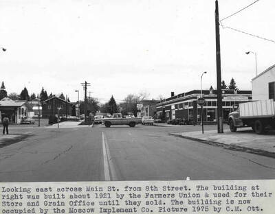 The building at right was built about 1921 by the Farmers Union and used for their store and grain office until they sold. The building is now occupied by the Moscow Implement Company. Picture 1975 by Clifford M. Ott.
