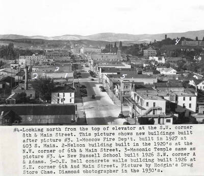 #4 This picture shows new buildings built after picture #3 [90-3-062c]. 1- Moscow Fire Department built in 1927 at 603 South Main Street. 2-Nelson building built in 1920s at the northwest corner of Sixth and Main streets. 3- Masonic Temple same as picture #3 [90-3-062c]. 4- New Russell School built 1926, southwest corner of A and Adams streets. 5- O.E. Bell, concrete walls build-in built 1926 at southeast corner of Sixth and Main streets. Picture by Hodgin's Drug Store, Charles Dimond photographer in the 1930s.