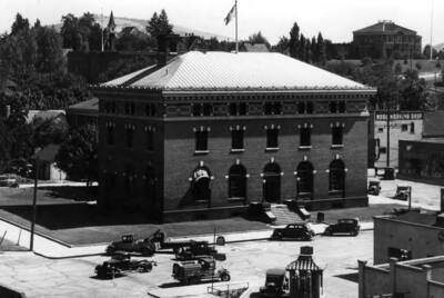 Built beginning May 2, 1910 and finished July 1, 1911. Located northeast corner of Third and Washington streets. First Courthouse top right, Presbyterian Church top left, about 1930.