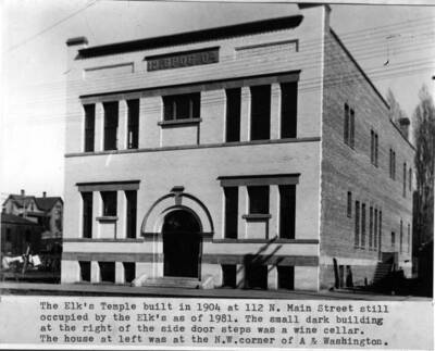 Built in 1904 at 112 North Main Street, still occupied by the Elks as of 1981. Small dark building at the right of the side door steps was a wine cellar. House at left was at the northwest corner of A and Washington streets.