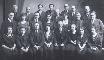Back row, left to right: Harvey J. Smith, John L. Woody, Homer E. Estes, Charlie Summerfield, E.J. Gemmill, John Nesbit, John Cone. Second row, [left to right:] Elmer M. Paulson, Emma Junge Sayles, Glen Grice, Lillian M. Skattaboe, Gillis D. Hodge, Edna M. Theriault, George K. Moody, Harry A. Thatcher. Front row, [left to right:] Bessie Walters Babcock, Daniel W. Burr, Adrian Nelson, Ione Adair, Columbus Clark, Hattie Matheney, Juanita Dix, Hazel Seeley