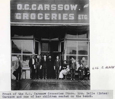 Mrs. Belle (Estes) Carssow and one of her children seated on the bench. 616 South Main Street.