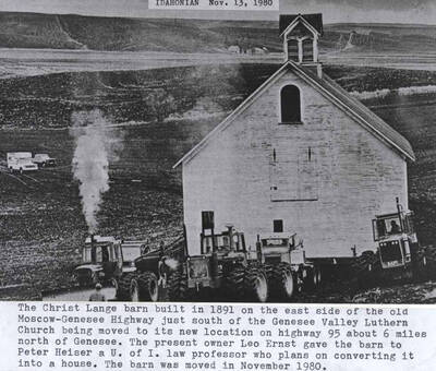 Built in 1891 on the east side of the old Moscow-Genesee Highway just south of the Genesee Valley Lutheran Church being moved to its new location on Highway 95 about 6 miles north of Genesee. The present owner Leo Ernst gave the barn to Peter Heiser, a University of Idaho law professor who plans on converting it into a house. The barn was moved in November 1980. [Wording on photo: 'Idahonian Nov. 13, 1980'].