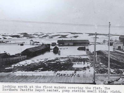 The Northern Pacific [Railroad] depot ,center, pump station small building, right. Wording on photo: 'Mar. 1.1910.'